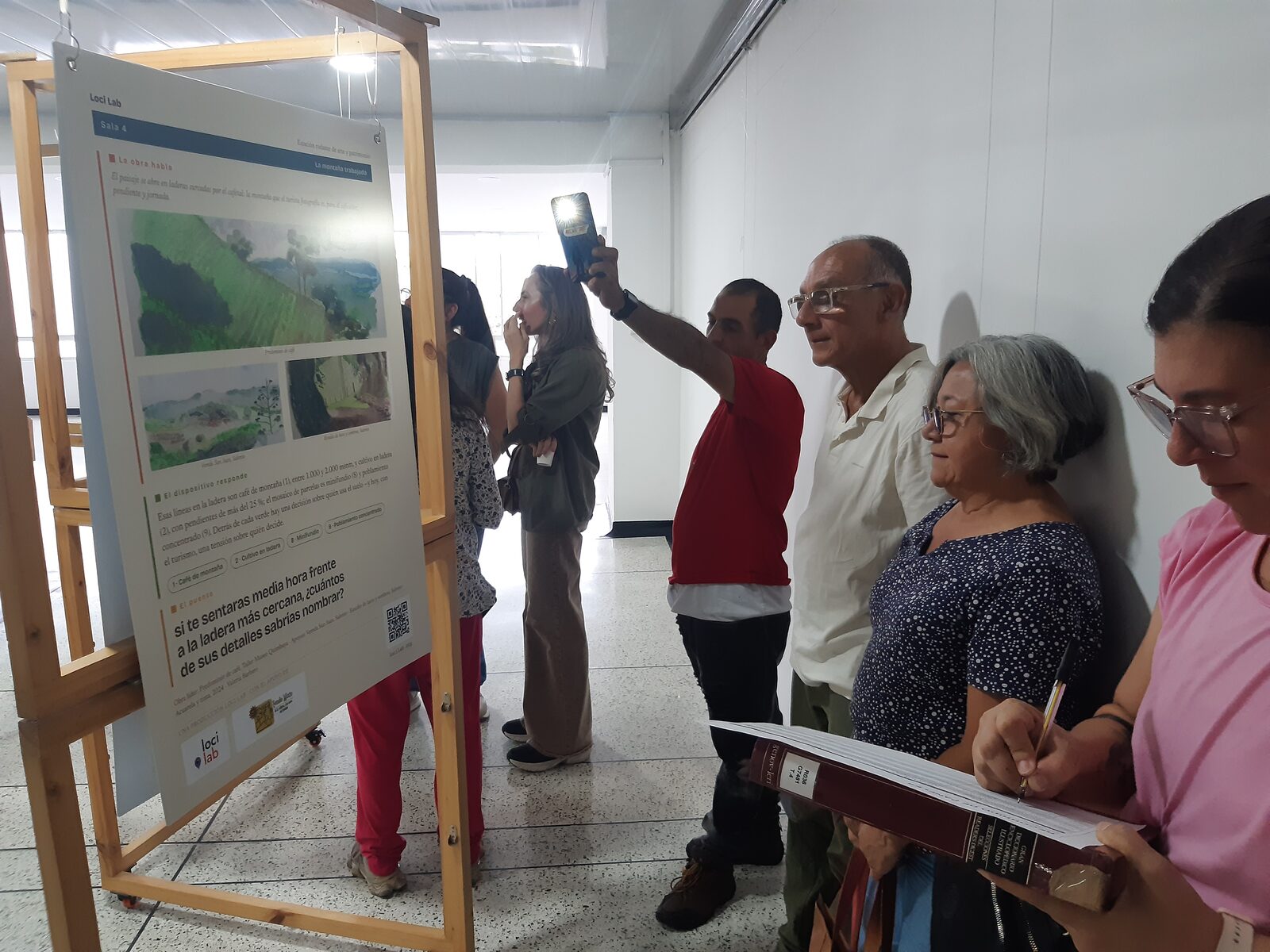 Público recorriendo la exposición El Paisaje Portable en la Biblioteca de la Sociedad de Mejoras Públicas de Armenia